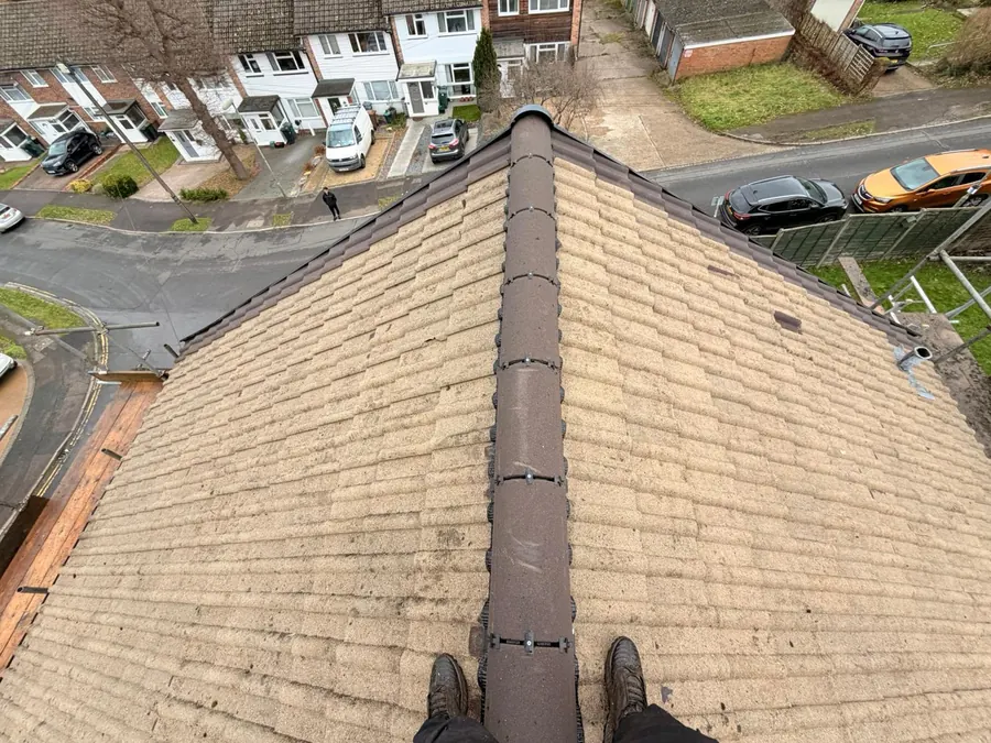Ridge line finished on a tiled roof above the street, FR Roofing Solutions