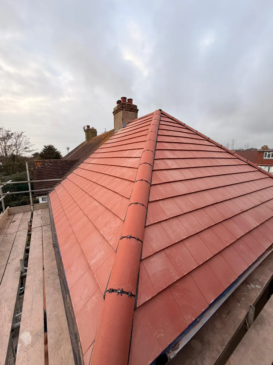 New red tile roof with a dry ridge running to the chimney, FR Roofing Solutions