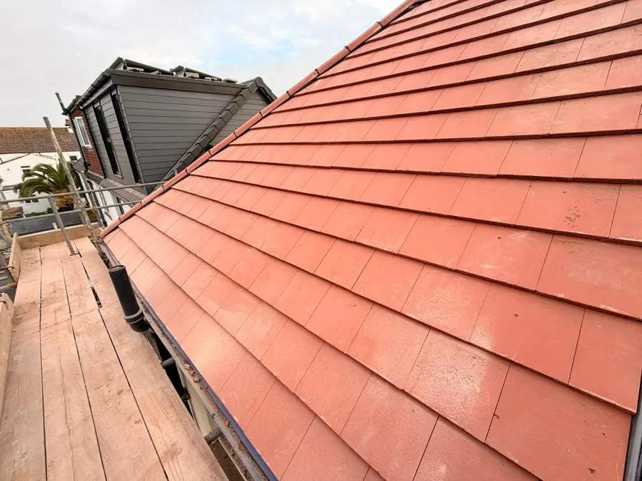 Finished red tile re-roof seen from the scaffold, FR Roofing Solutions
