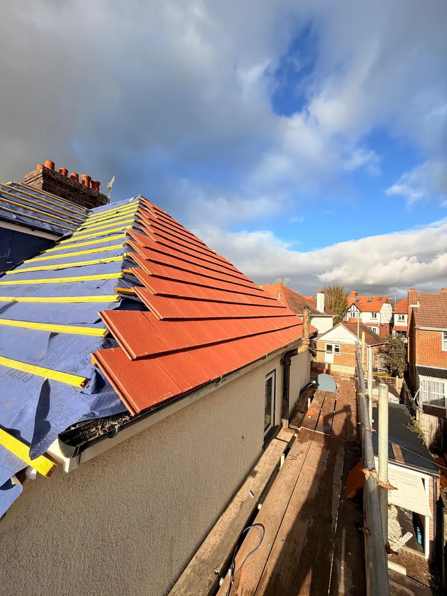Red tiles going on over new felt and battens, FR Roofing Solutions