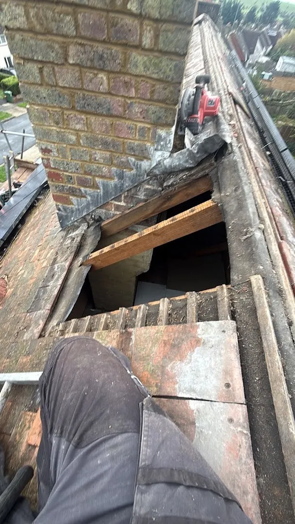 Damaged section opened next to the chimney for repair, FR Roofing Solutions