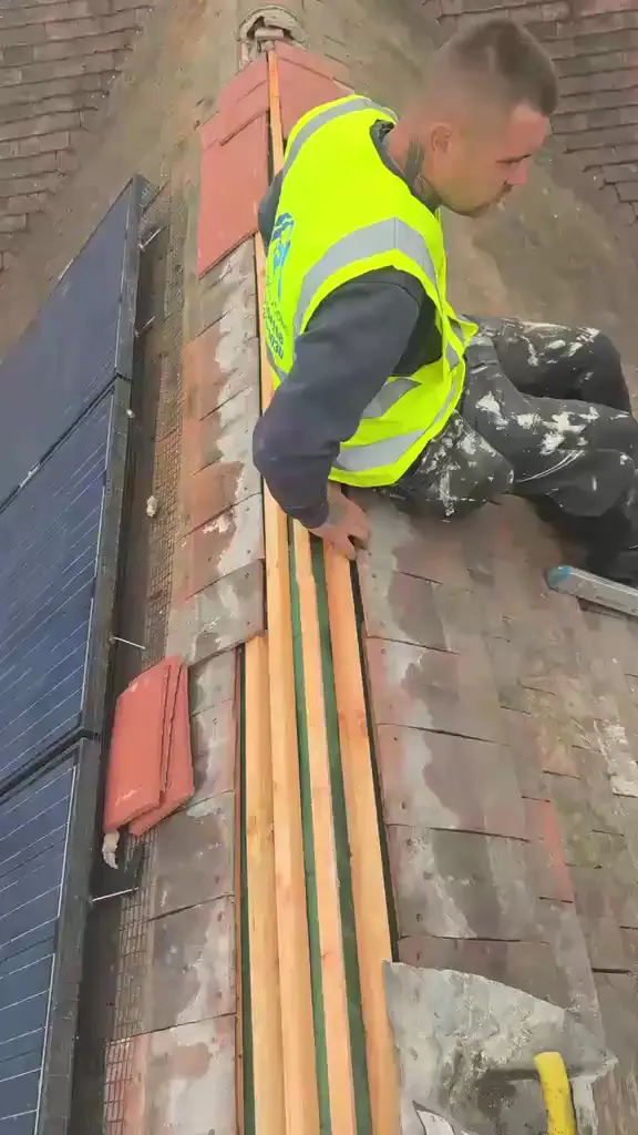 Roofer in hi-vis fixing battens at the ridge, FR Roofing Solutions