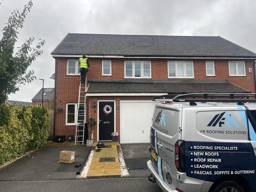 FR Roofing Solutions van on the drive of a semi, ladder up, FR Roofing Solutions