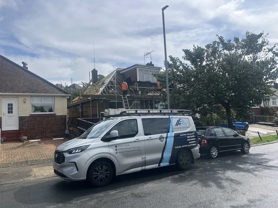 FR Roofing Solutions van parked by a scaffolded roof, FR Roofing Solutions